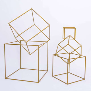 Gold geometric wire sculptures in varying sizes on a white background.