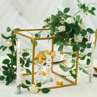 Elegant centerpieces with candles and greenery for a stylish table setting.