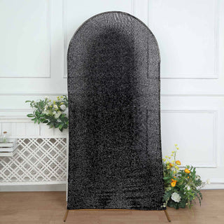 Black textured backdrop on a stand with floral accents.