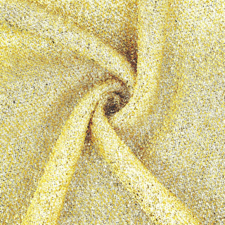 Gold textured fabric with a shimmering finish, perfect for elegant designs.