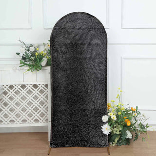Black sequin backdrop with floral accents, ideal for photoshoots or events.