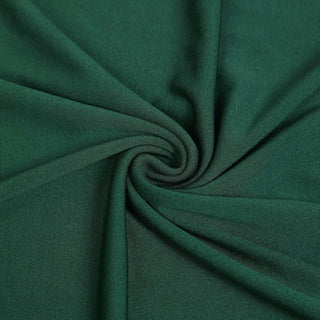 Green fabric texture with a smooth, swirling pattern.