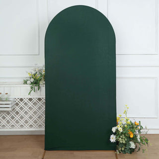 Green arch backdrop with floral arrangement at the base.