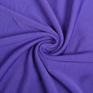 Purple fabric texture in a swirling pattern.
