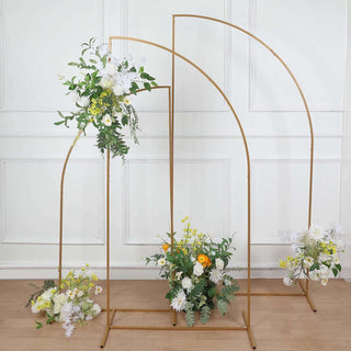 Gold arch floral display with vibrant flowers arranged at the base.