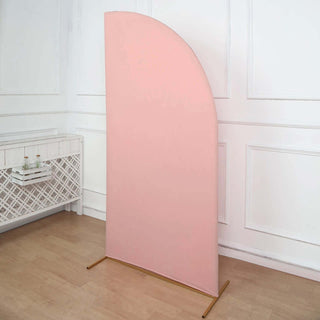 Pink curved backdrop stand with gold base in a minimalistic setting.