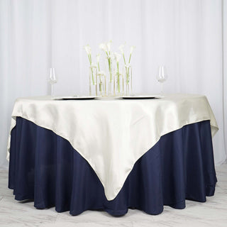 Elegant two-tone tablecloth with navy and cream colors for event decor.