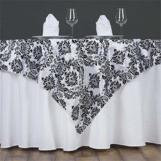 Black and white floral tablecloth draped elegantly over a dining table.