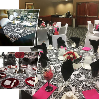 Elegant black and white table settings with floral accents in a banquet hall.