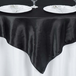 Black satin tablecloth draped elegantly over a white table.