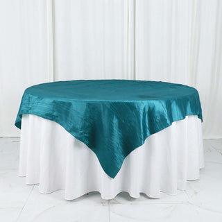 Add Elegance to Your Tablescape with the Peacock Teal Accordion Crinkle Taffeta Table Overlay Add Elegance to Your Tablescape with the Peacock Teal Accordion Crinkle Taffeta Table Overlay