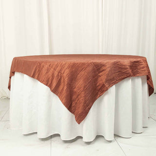 Copper textured tablecloth draped over a round table.
