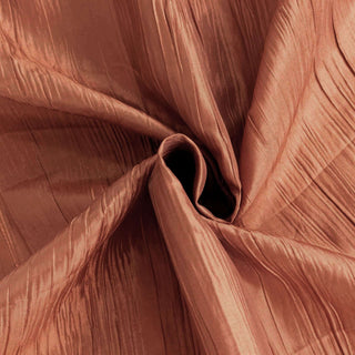 Textured bronze fabric swirl close-up for elegant design projects.