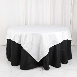 Round table with white tablecloth and black skirt