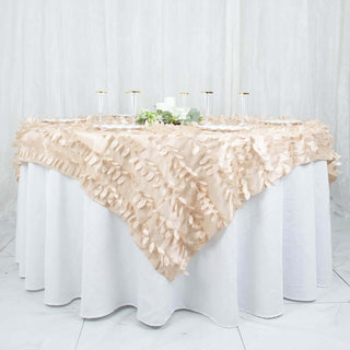 Elegant beige tablecloth with leaf design draped over a round table.