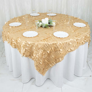 Elegant gold leaf tablecloth with white plates on a round dining table.