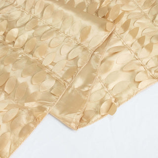 Gold textured fabric with leaf patterns on a white background.