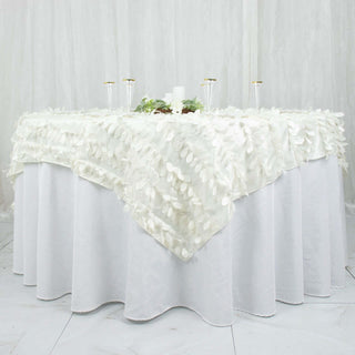White table adorned with a textured leaf-patterned tablecloth for elegant settings.