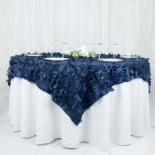 Navy blue tablecloth with leaf design on a round table setting.