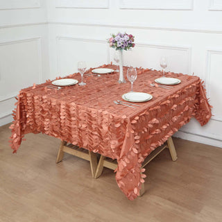 Elegant peach tablecloth with leaf design set for dining.