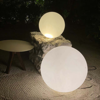 Modern spherical lamps on a stone surface, emitting a soft glow.