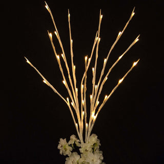 White LED branch lights with floral base arrangement.