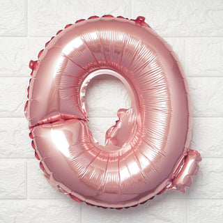Rose gold number 0 balloon on a textured white background.