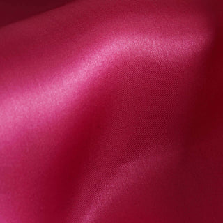 Bright fuchsia satin fabric with a smooth texture.