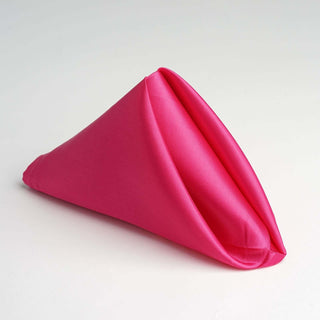 Pink fabric napkin elegantly folded into a cone shape