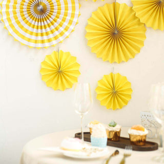 Yellow paper fans and decorations for a festive celebration.