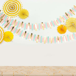Colorful paper decorations with yellow and pastel accents for festive occasions.