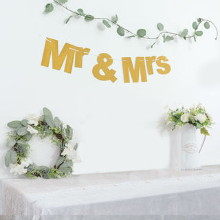 Add Sparkle to Your Wedding or Anniversary Party with the 3ft Gold Glittered Mr and Mrs Paper Hanging Banner