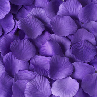 Purple silk rose petals scattered on a surface.