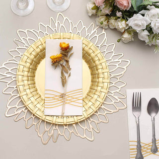 Elegant gold charger plate with floral napkin and cutlery on a decorative table setting.