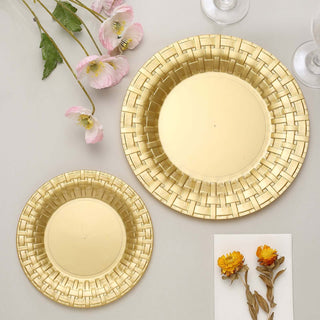 Gold decorative plates in two sizes on a neutral backdrop with flowers.