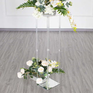 Acrylic flower stand with white roses and greenery.