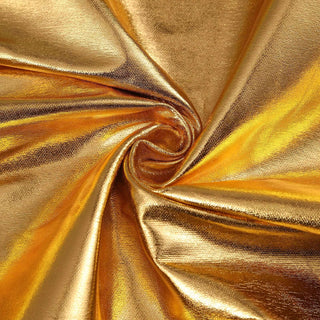 Shiny gold fabric with a swirling texture pattern.