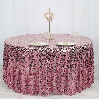 Round sequined tablecloth in pink shades on a banquet table with crown centerpiece.