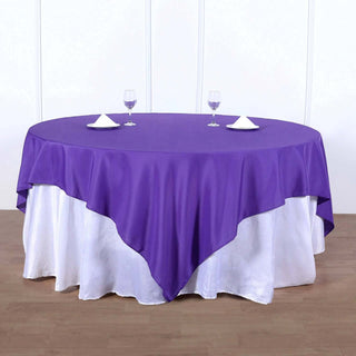 Add Elegance to Your Event with the 90"x90" Purple Square Polyester Table Overlay Add Elegance to Your Event with the 90"x90" Purple Square Polyester Table Overlay