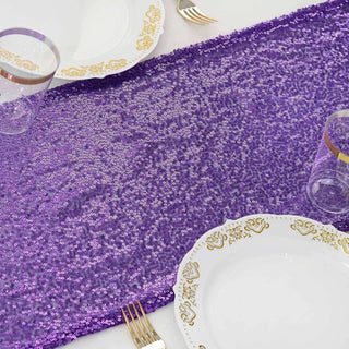 Purple sequin table runner with elegant dinnerware set.