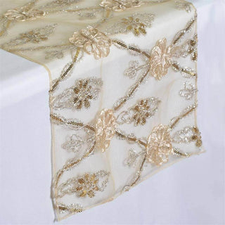 Embroidered table runner with floral design in gold and silver tones.