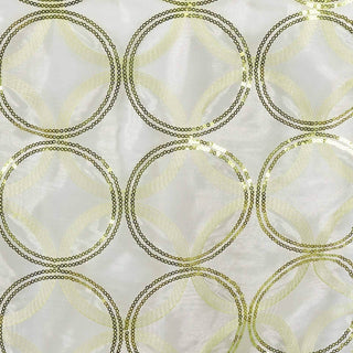 Sequin fabric with circular pattern in gold and light green.