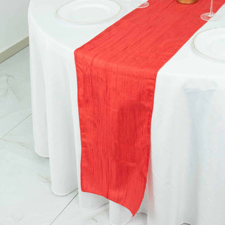 Red table runner on a white tablecloth for elegant dining settings.