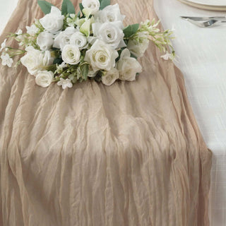 Elegant beige table runner with white floral arrangement on a dining table.