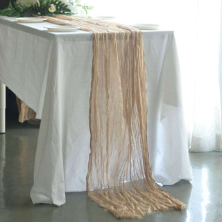 Textured table runner in neutral tones draped over a white table.