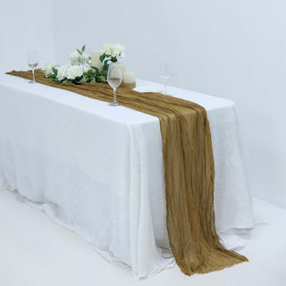Elegant brown table runner on a white table with flowers and glasses.