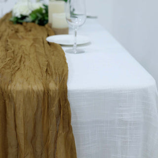 Elegant brown table runner on a white tablecloth for stylish dining decor.