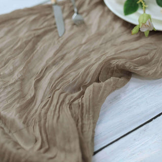 Textured brown fabric draped elegantly on a table with utensils and plate.