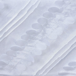 White fabric with raised circular patterns creating a textured design.