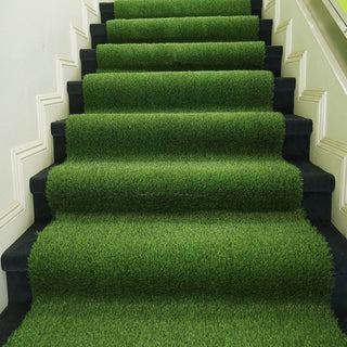 Artificial grass carpet on staircase steps for a vibrant, green look.